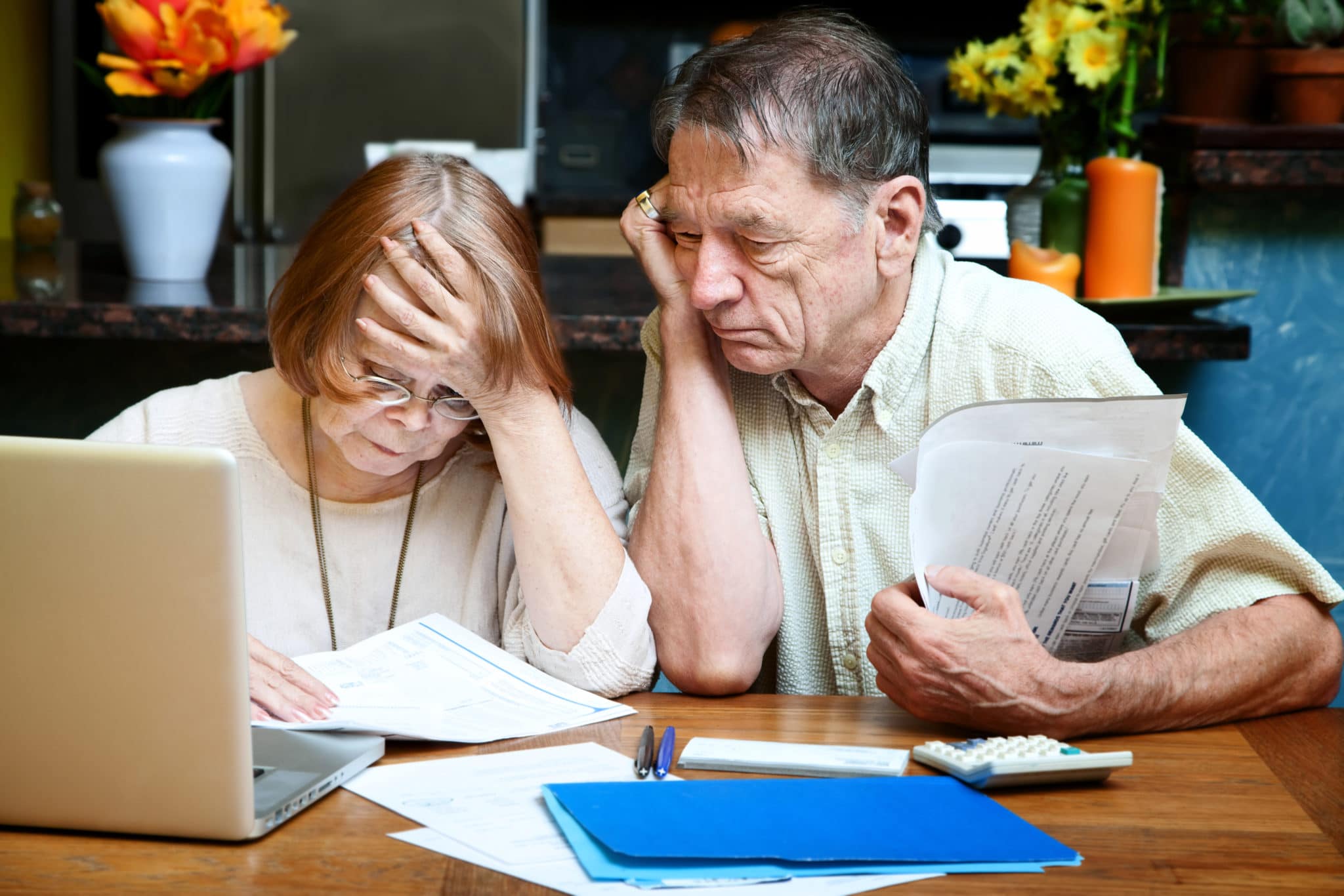 Worried Man and Woman Sitting at Table